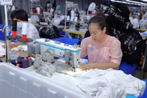 OEM clothing manufacturer workers producing custom apparel in factory