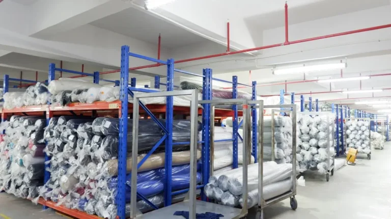 Fabric inventory stored in warehouse for custom apparel manufacturing at Beyson Apparel