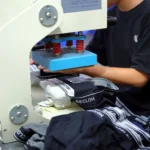 Skilled artisan executing detailed custom heat transfer on private label men's underwear during a low MOQ production run.